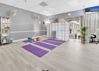 Spacious yoga room with mats at Spa Wellness Services, Greenacres, Florida, US, offering a calm retreat.