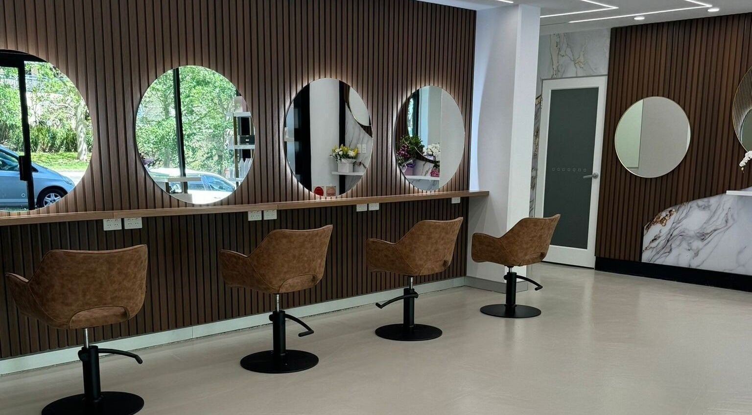 Sleek interior of Riviera Beauty Salon - Sydney in Rockdale, New South Wales, AU, showcasing modern styling chairs.