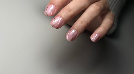 Elegant pink nails with silver accents at Nails Lab, Calgary, Alberta, CA. Perfect manicure for a chic look.