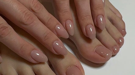 Manicured hands and pedicured feet with nude polish at Nails Lab, Calgary, Alberta, CA.