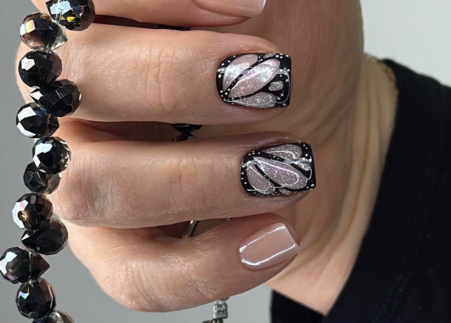 Glamorous nail art at Nails Lab, Calgary, Alberta, CA featuring intricate black and pink designs.