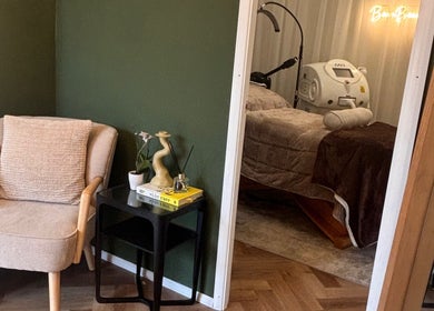 Cozy chair and treatment bed at Beam Beauty Studio, Tamworth, England, GB, offering a serene ambiance.