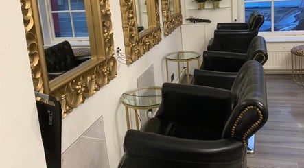 Luxurious seating at AE HAIR in Grimsby, England, GB with ornate mirrors reflecting stylish decor.