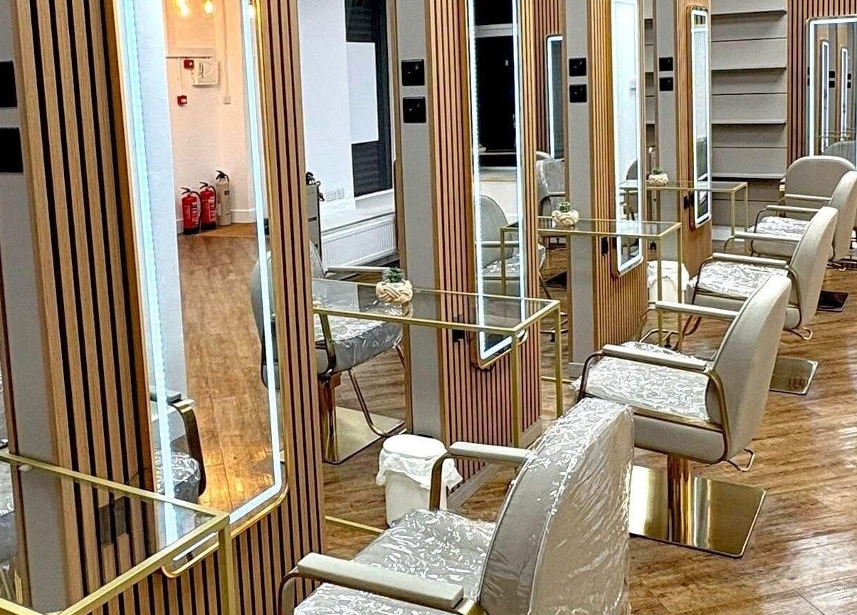 Elegant salon chairs and mirrors at AE HAIR, Grimsby, England. Discover luxury beauty experiences.