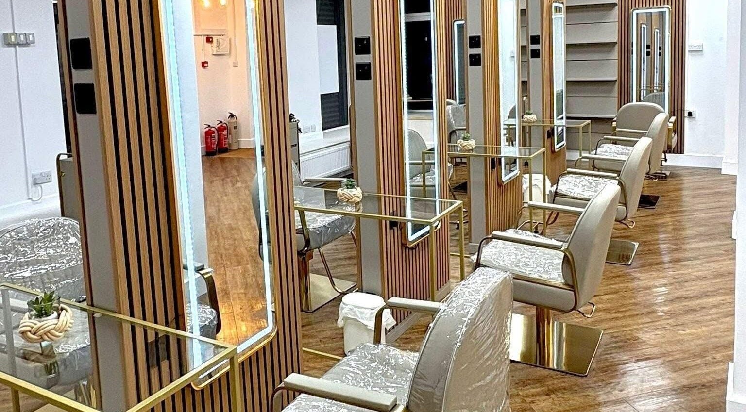 Elegant salon chairs and mirrors at AE HAIR, Grimsby, England. Discover luxury beauty experiences.