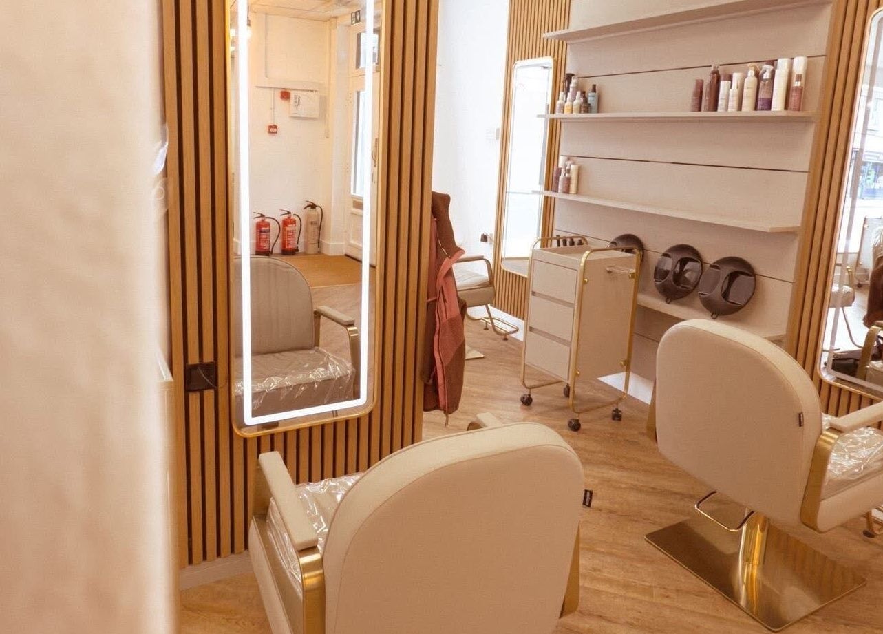 Modern salon interior at AE HAIR in Grimsby, England, GB featuring stylish chairs and mirrors.