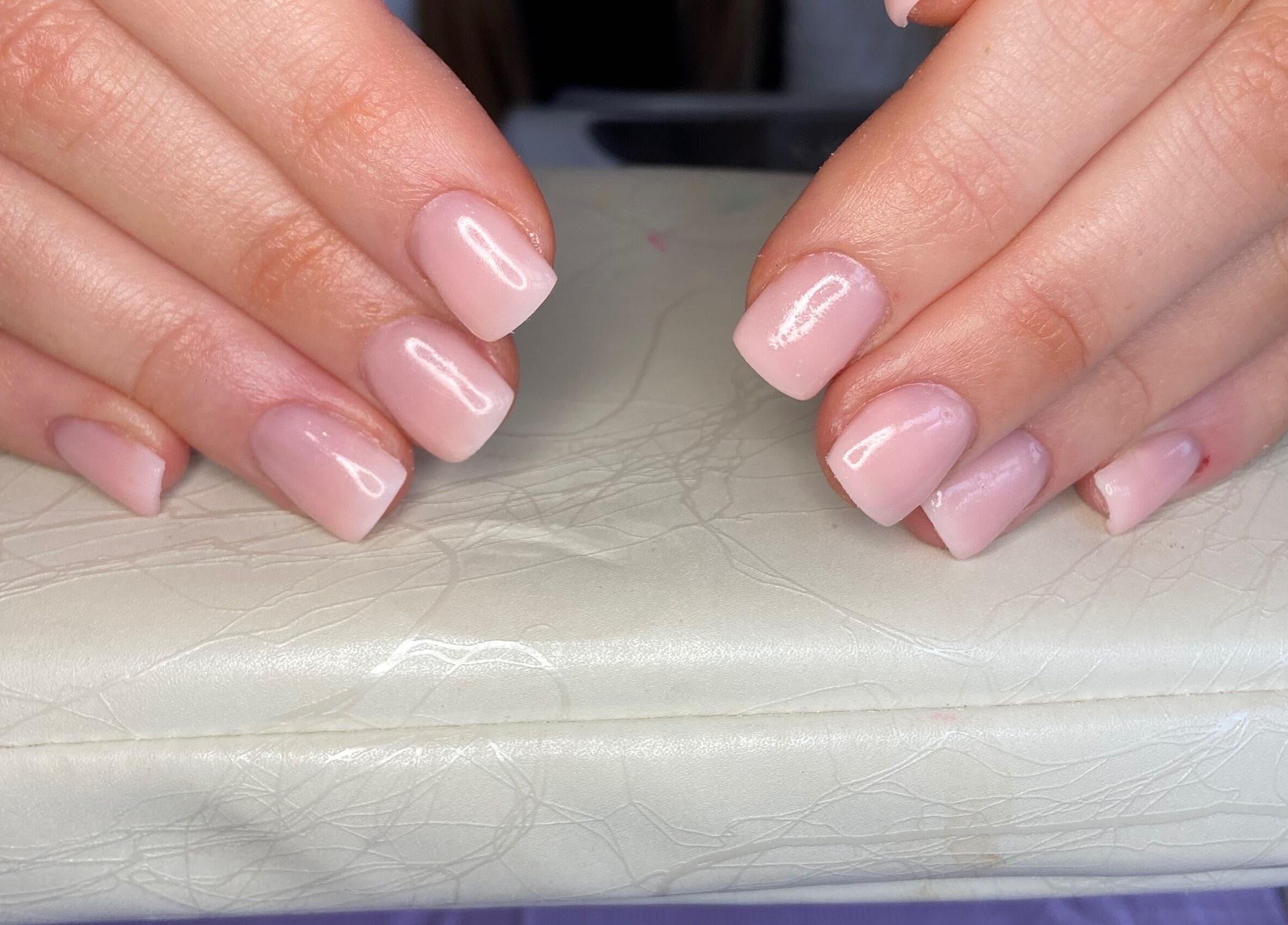 Elegant pink manicure at Aqua Nails and Beauty, Bradford, England, GB showcasing glossy finish.