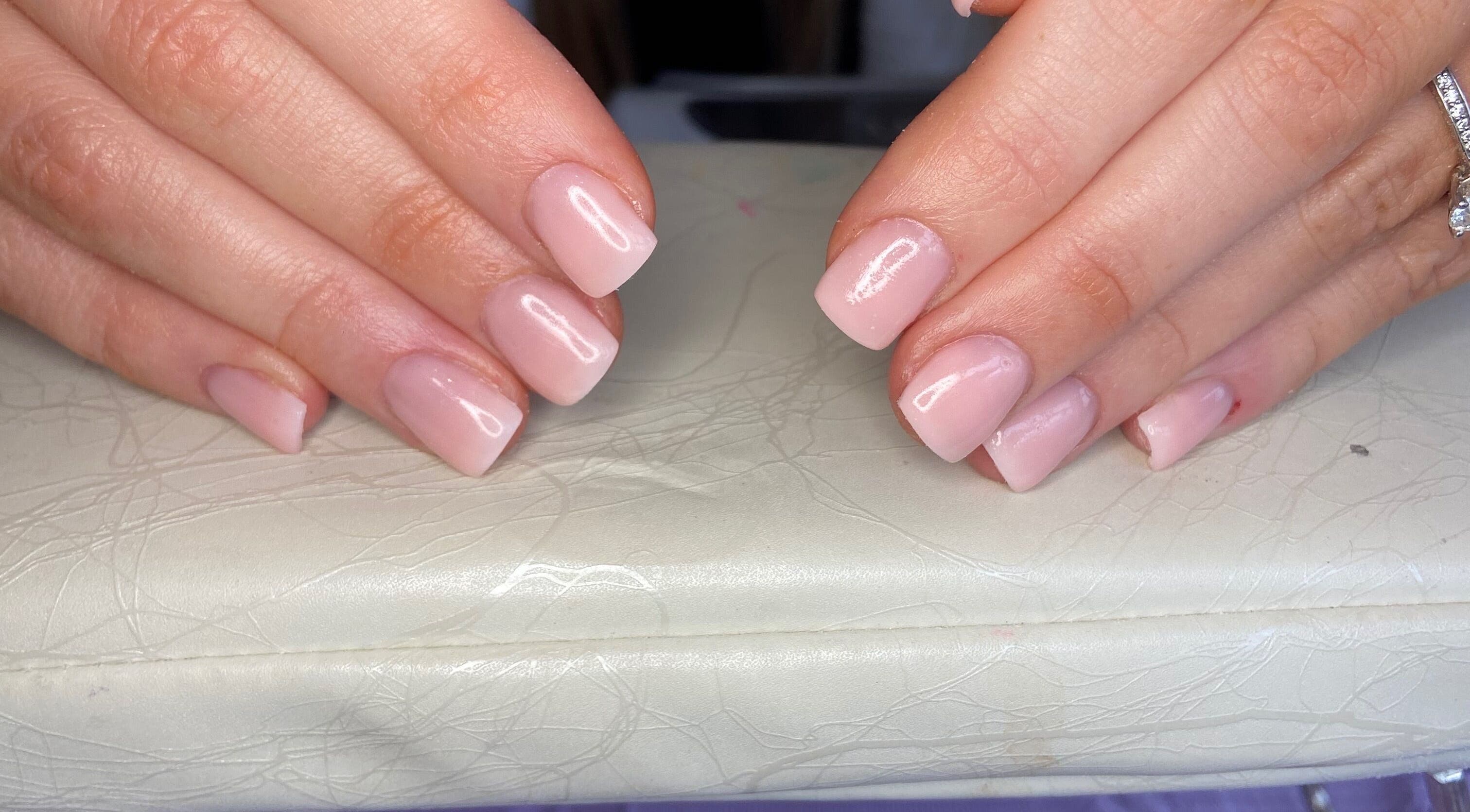 Elegant pink manicure at Aqua Nails and Beauty, Bradford, England, GB showcasing glossy finish.