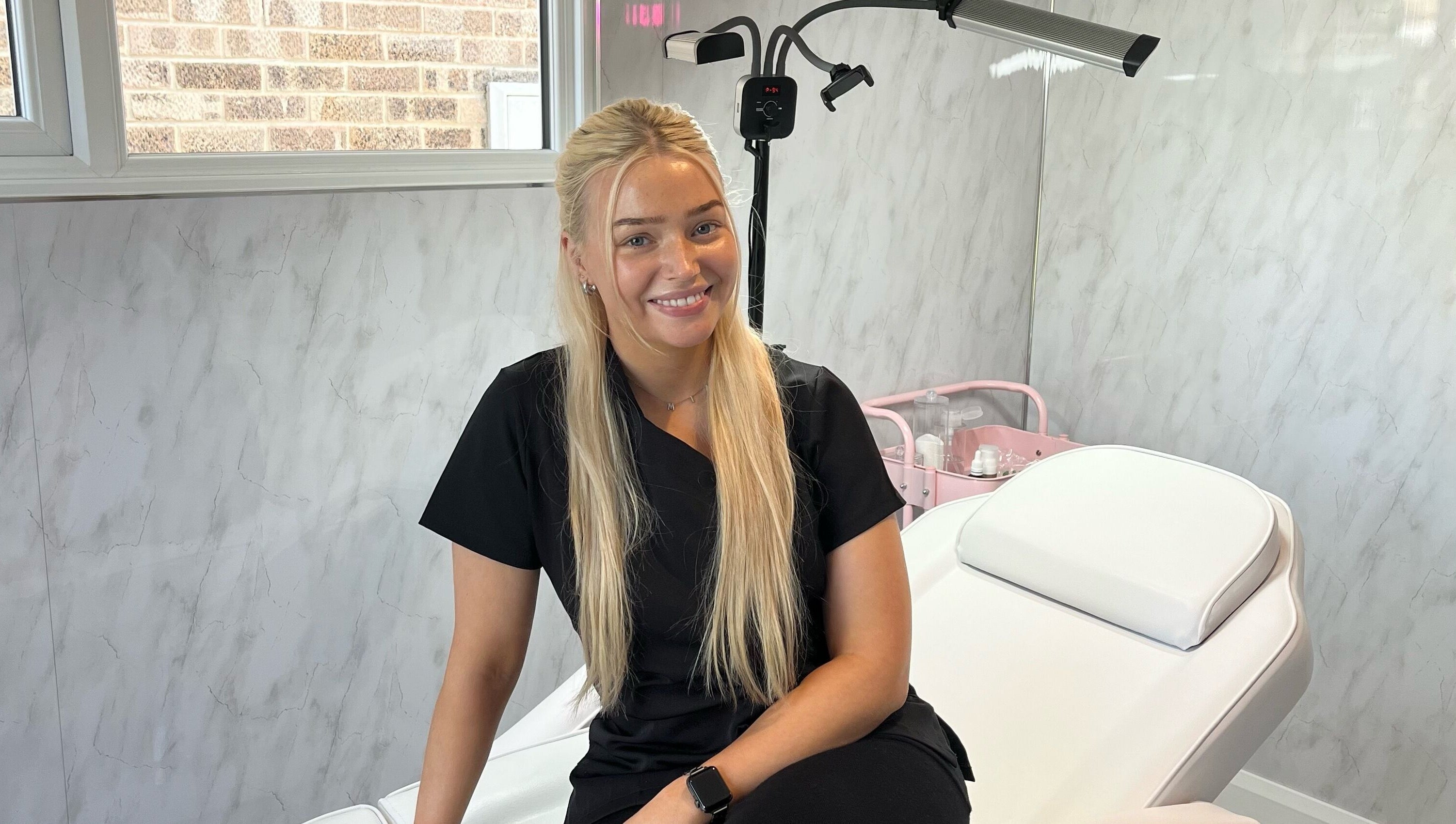 Professional beautician at TweaksByMia in Colchester, England, GB, ready in a serene treatment room.