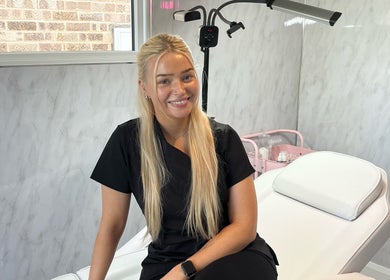 Professional beautician at TweaksByMia in Colchester, England, GB, ready in a serene treatment room.