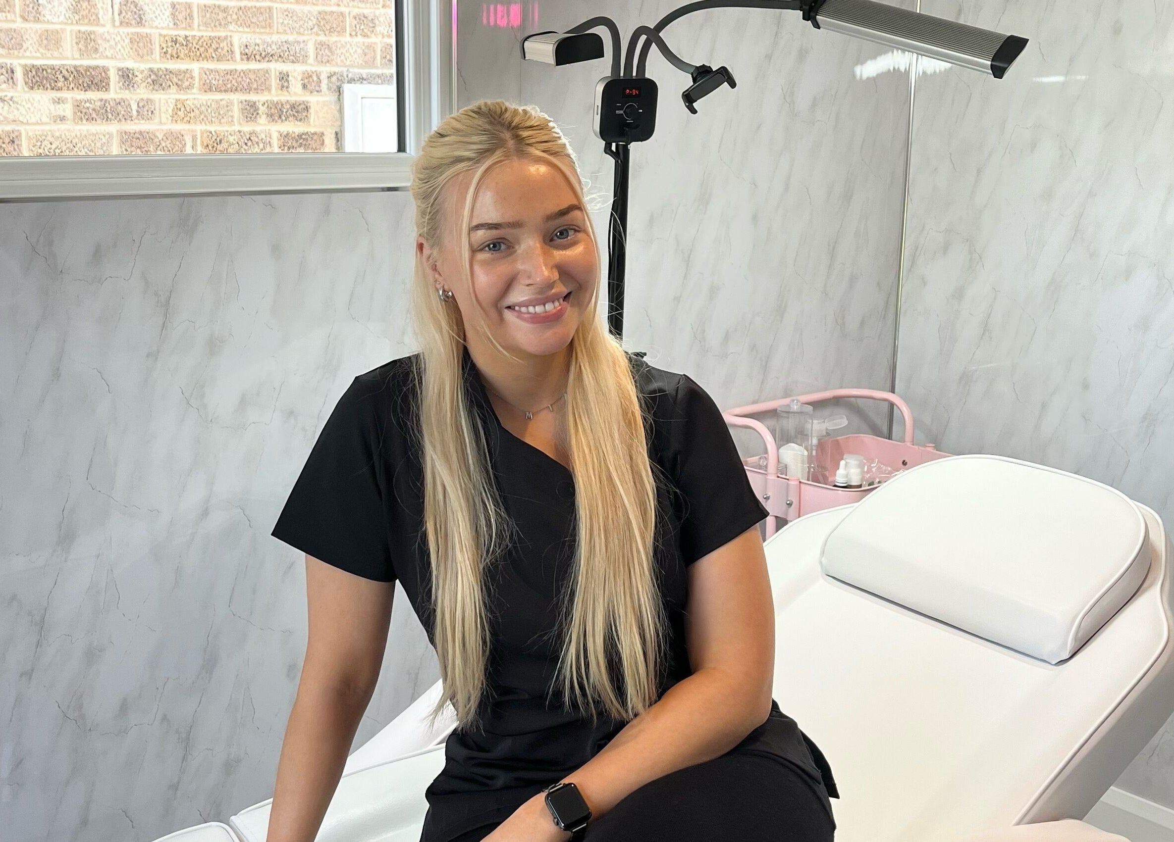 Professional beautician at TweaksByMia in Colchester, England, GB, ready in a serene treatment room.