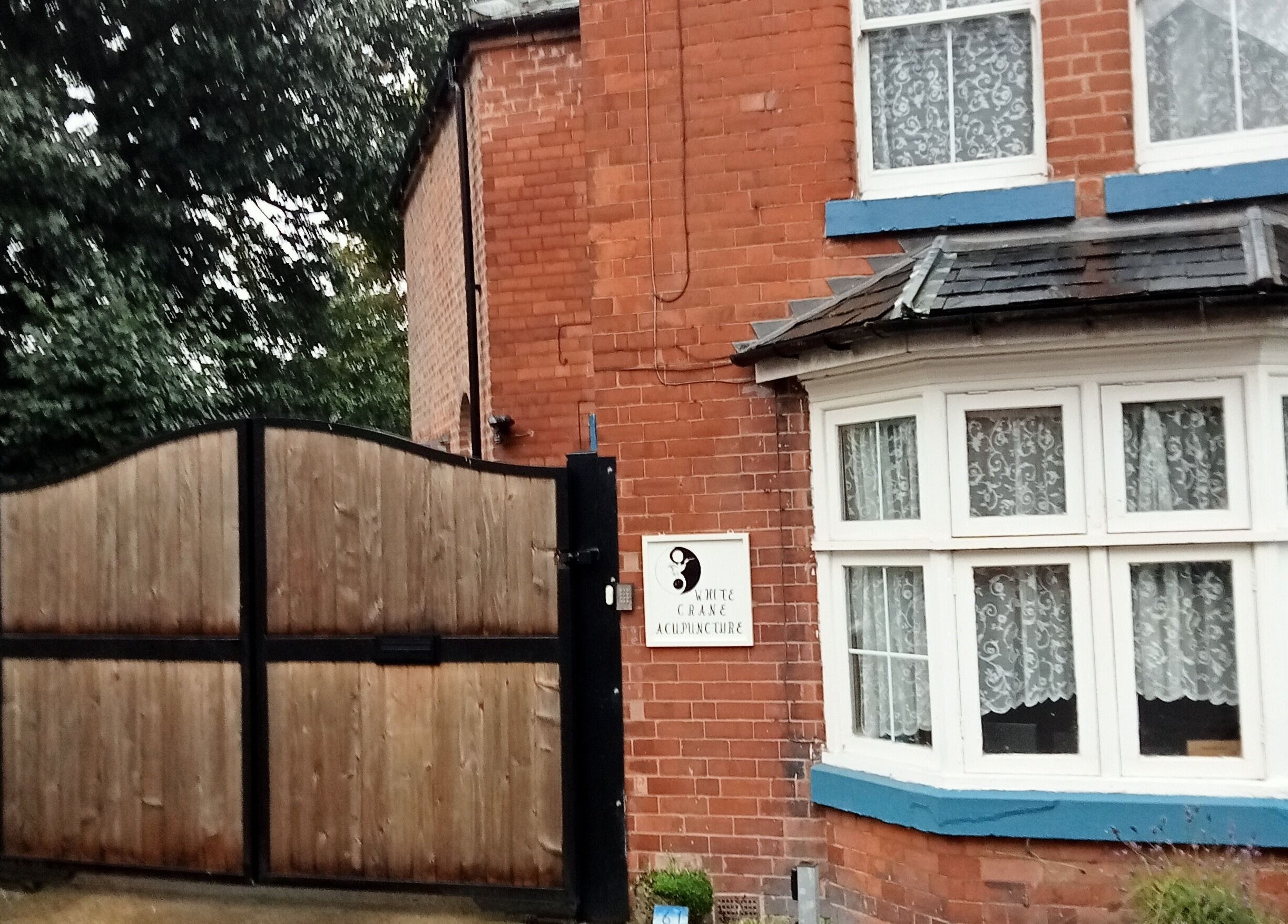 Entrance of White Crane Acupuncture with brick facade in Mansfield, GB.