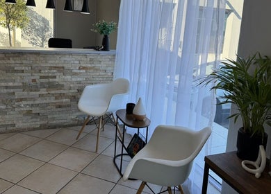 Elegant waiting area at Laser Erase - Centurion in Centurion, Gauteng, ZA with modern chairs and decor.