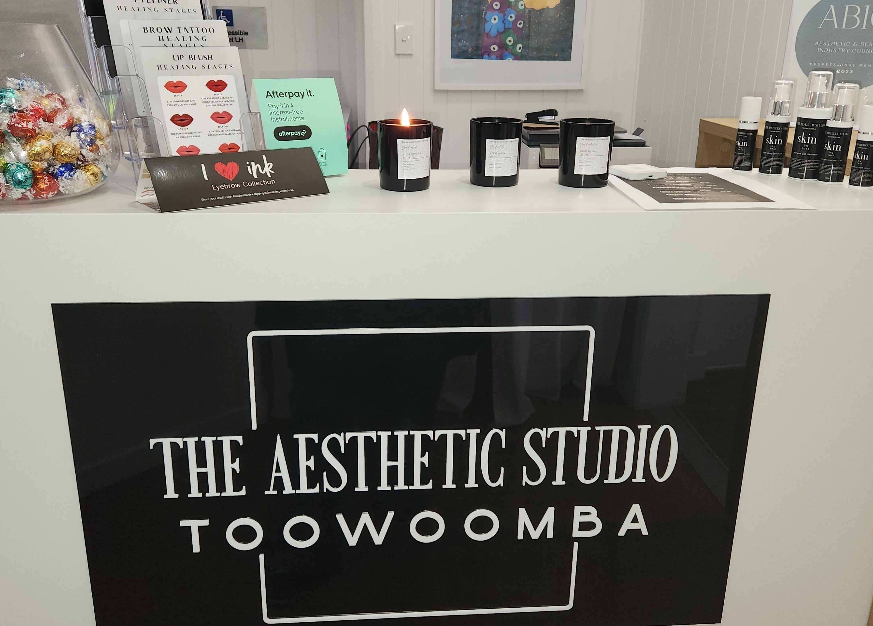 Reception counter at The Aesthetic Studio Toowoomba, featuring skincare products and decor. Toowoomba, Queensland, AU.