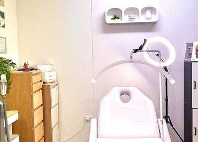Elegant treatment room at VM Cosmetic Clinic in Orange, New South Wales, AU showcasing modern equipment and certificates.