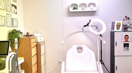 Elegant treatment room at VM Cosmetic Clinic in Orange, New South Wales, AU showcasing modern equipment and certificates.