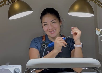 Skilled nail technician at Carli Manicure, Melbourne, Victoria, AU, perfects a client's nails under elegant lighting.