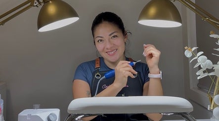 Skilled nail technician at Carli Manicure, Melbourne, Victoria, AU, perfects a client's nails under elegant lighting.