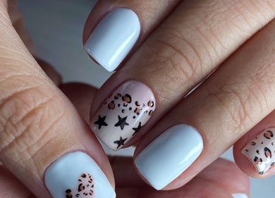 Stylish nail art at Carli Manicure, Melbourne, Victoria, AU, featuring white polish with star patterns.