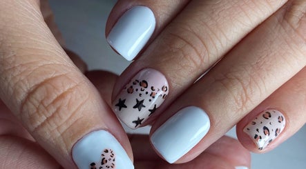 Stylish nail art at Carli Manicure, Melbourne, Victoria, AU, featuring white polish with star patterns.