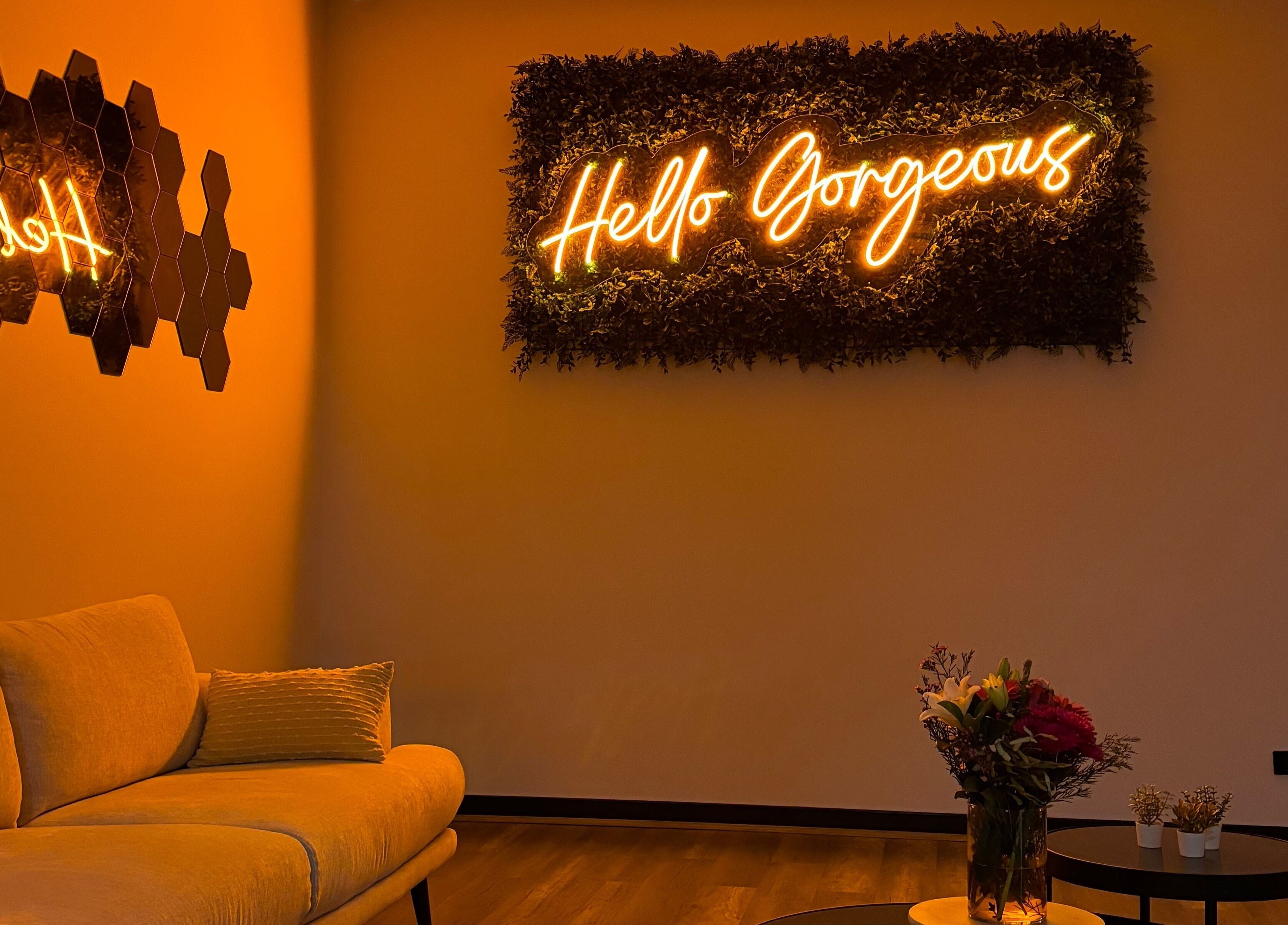 Cozy seating and 'Hello Gorgeous' neon at SakuraStudio | Spray Tan, Canning Vale, Western Australia, AU.