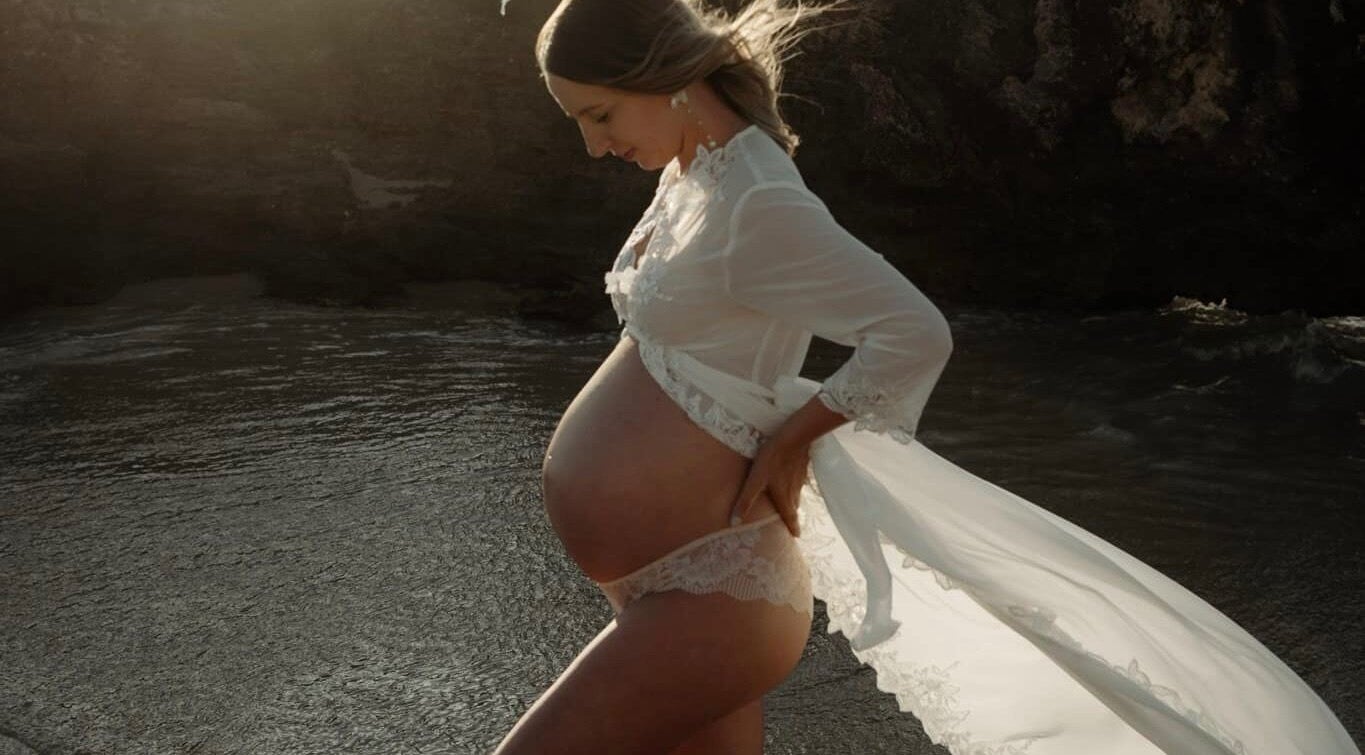 A pregnant woman in a lace robe at the beach, captured near SakuraStudio | Spray Tan, Canning Vale, Western Australia, AU.