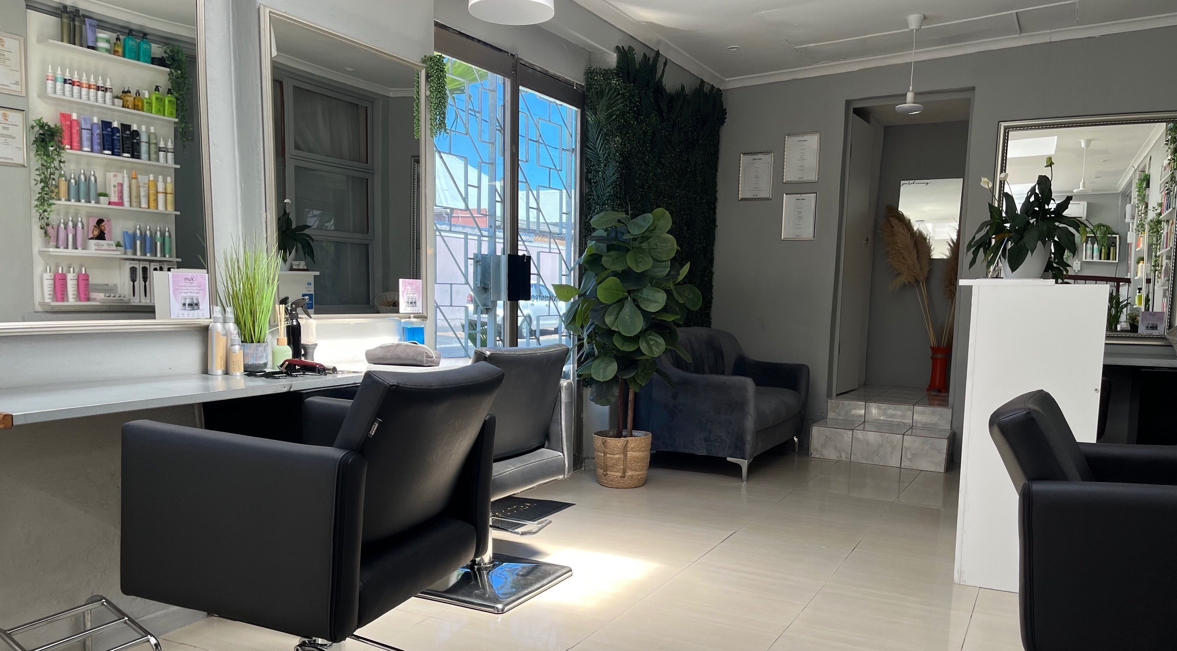 Bright, elegant interior of Another Lifestyles Hair Salon in Cape Town, Western Cape, ZA. Modern decor with chairs.