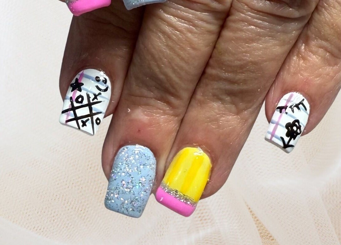 Creative nail art featuring colorful designs at Polished Nail and Brow Lounge, Dunedin, Florida, US.