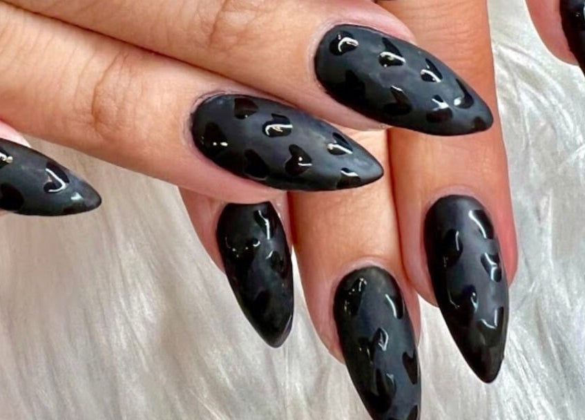 Stylish black nail art at Polished Nail and Brow Lounge, Dunedin, Florida, US, showcasing glossy heart design.