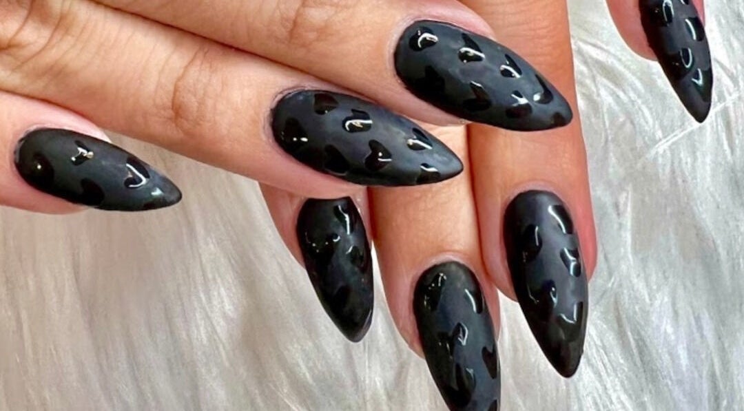 Stylish black nail art at Polished Nail and Brow Lounge, Dunedin, Florida, US, showcasing glossy heart design.