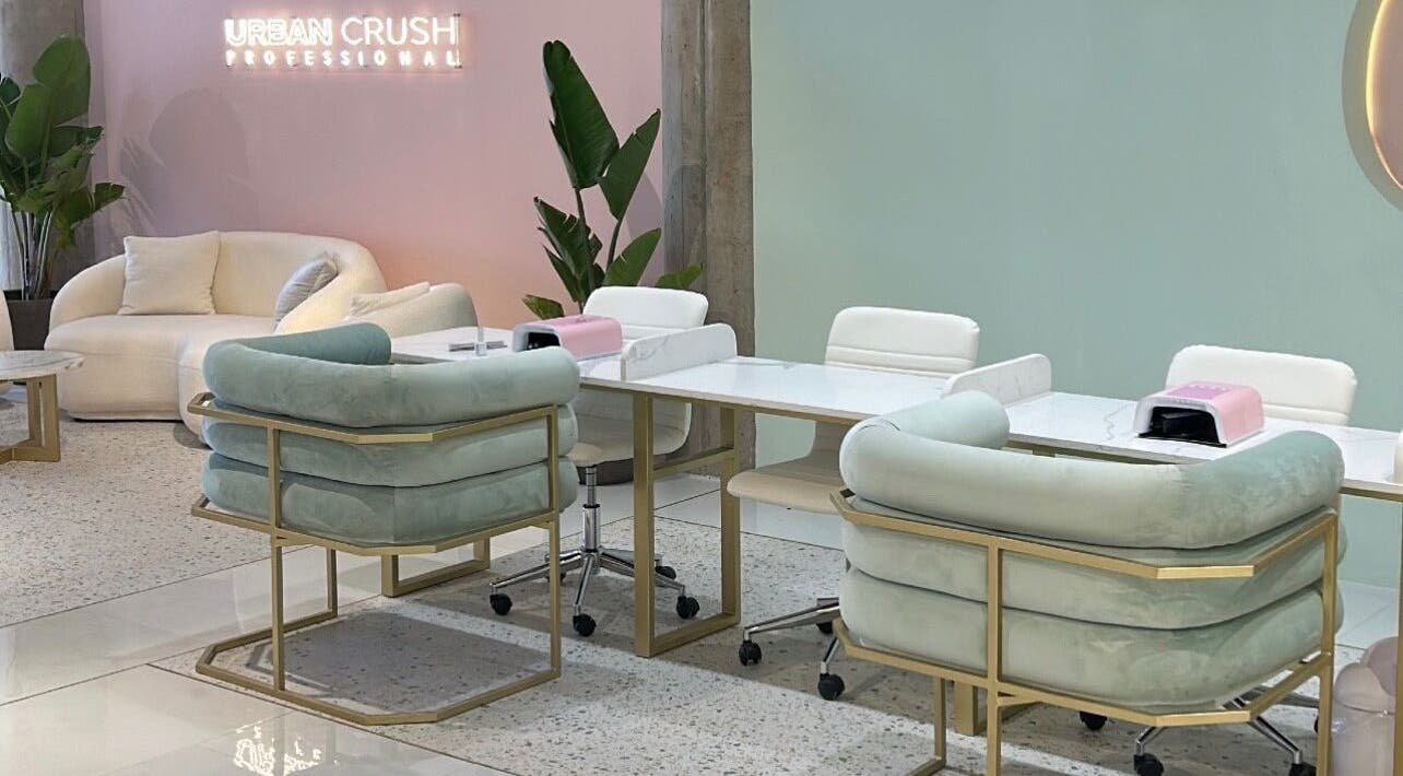 Stylish lounge at Urban Crush Professional - Sea Point, Cape Town, Western Cape, ZA with pastel seating and decor.