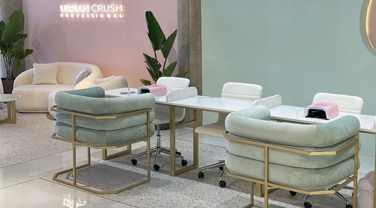 Stylish lounge at Urban Crush Professional - Sea Point, Cape Town, Western Cape, ZA with pastel seating and decor.