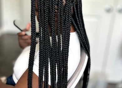Intricate braiding hairstyle at D’lene Hair, Thorold, Ontario, CA, showcasing expert styling in a relaxing setting.