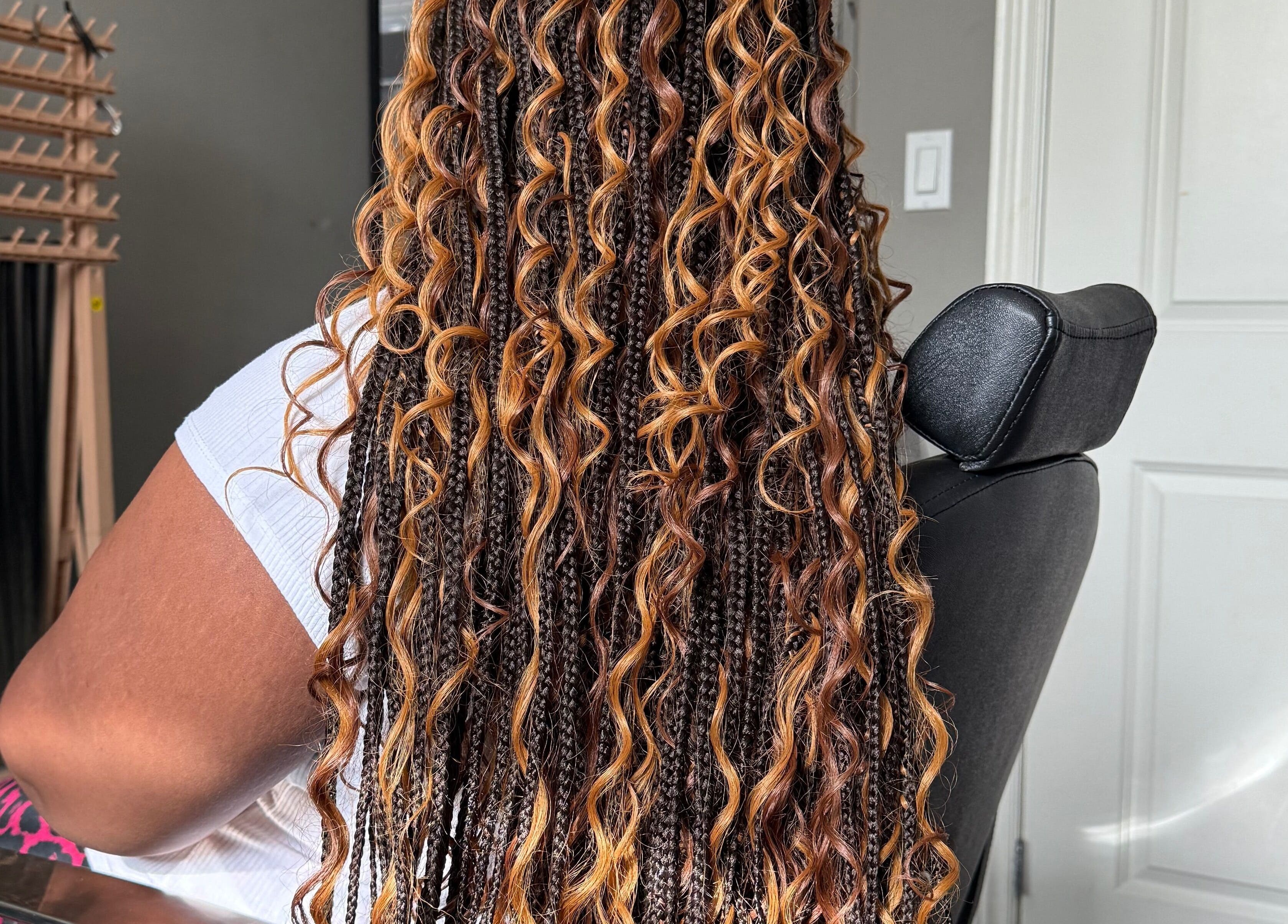 Intricate braided hairstyle at D’lene Hair in Thorold, Ontario, CA, showcasing vibrant curls.