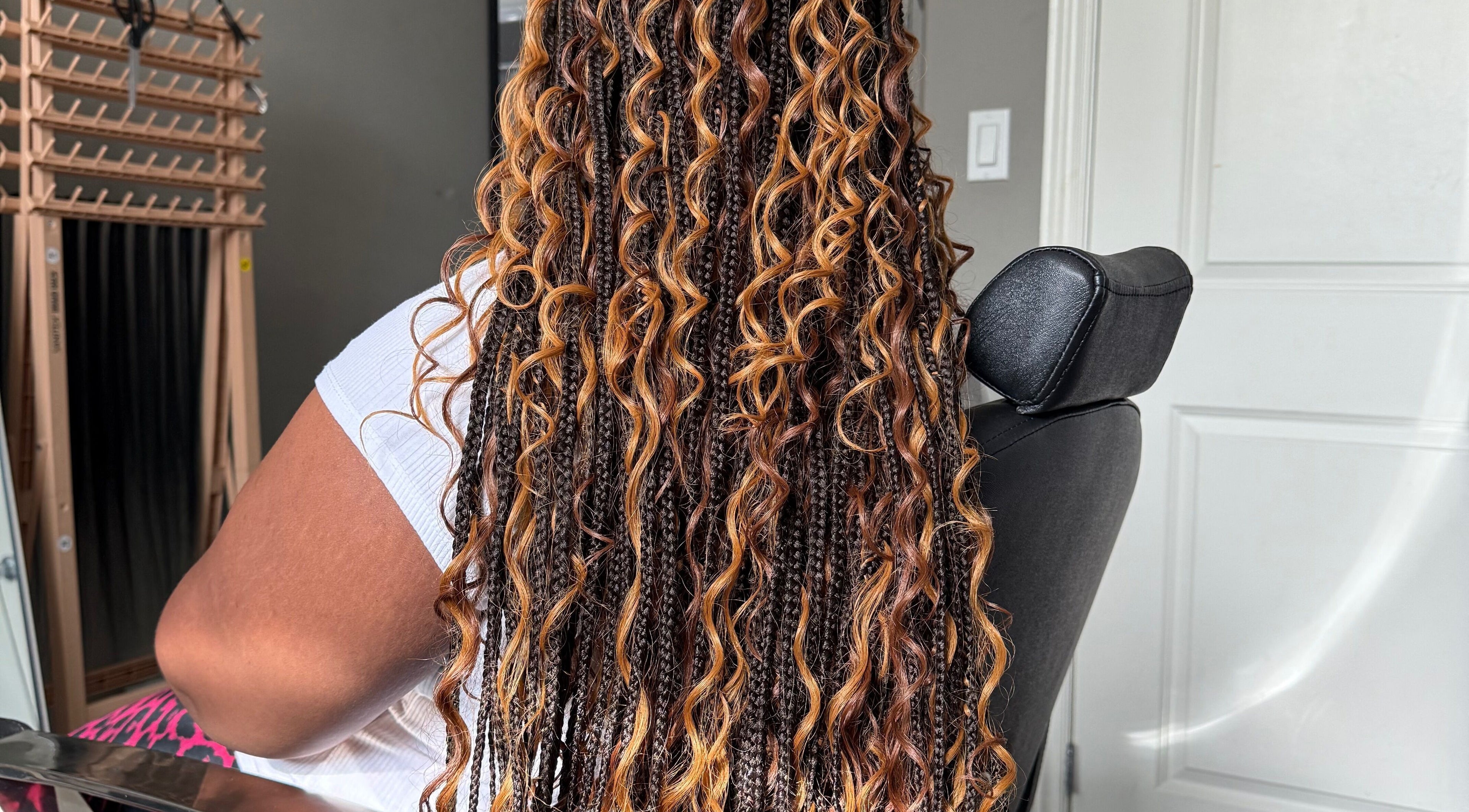 Intricate braided hairstyle at D’lene Hair in Thorold, Ontario, CA, showcasing vibrant curls.
