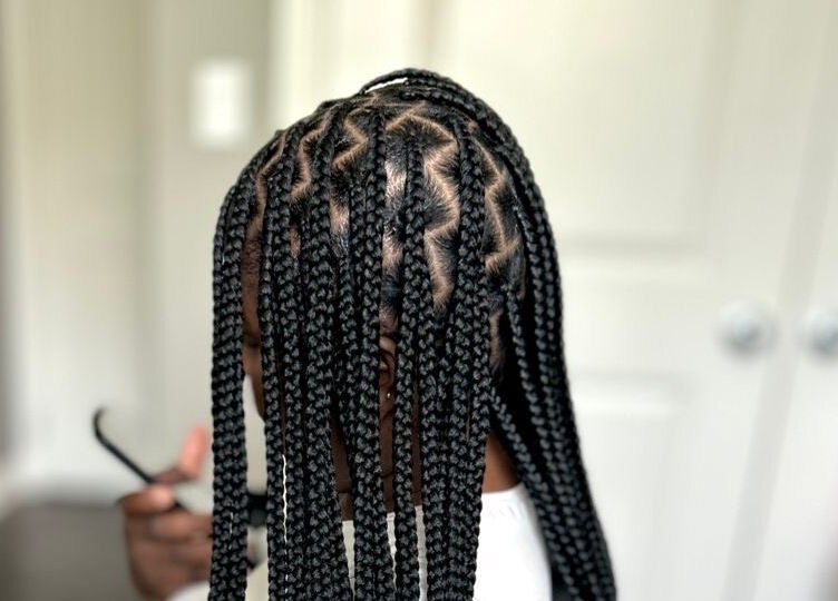 Intricate braided hairstyle at D’lene Hair in Thorold, Ontario, CA. Perfect for a unique look.