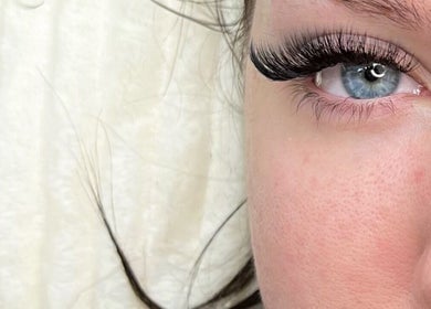Close-up of a blue eye with voluminous lashes at Lash Studio London, showcasing beauty in London, England, GB.