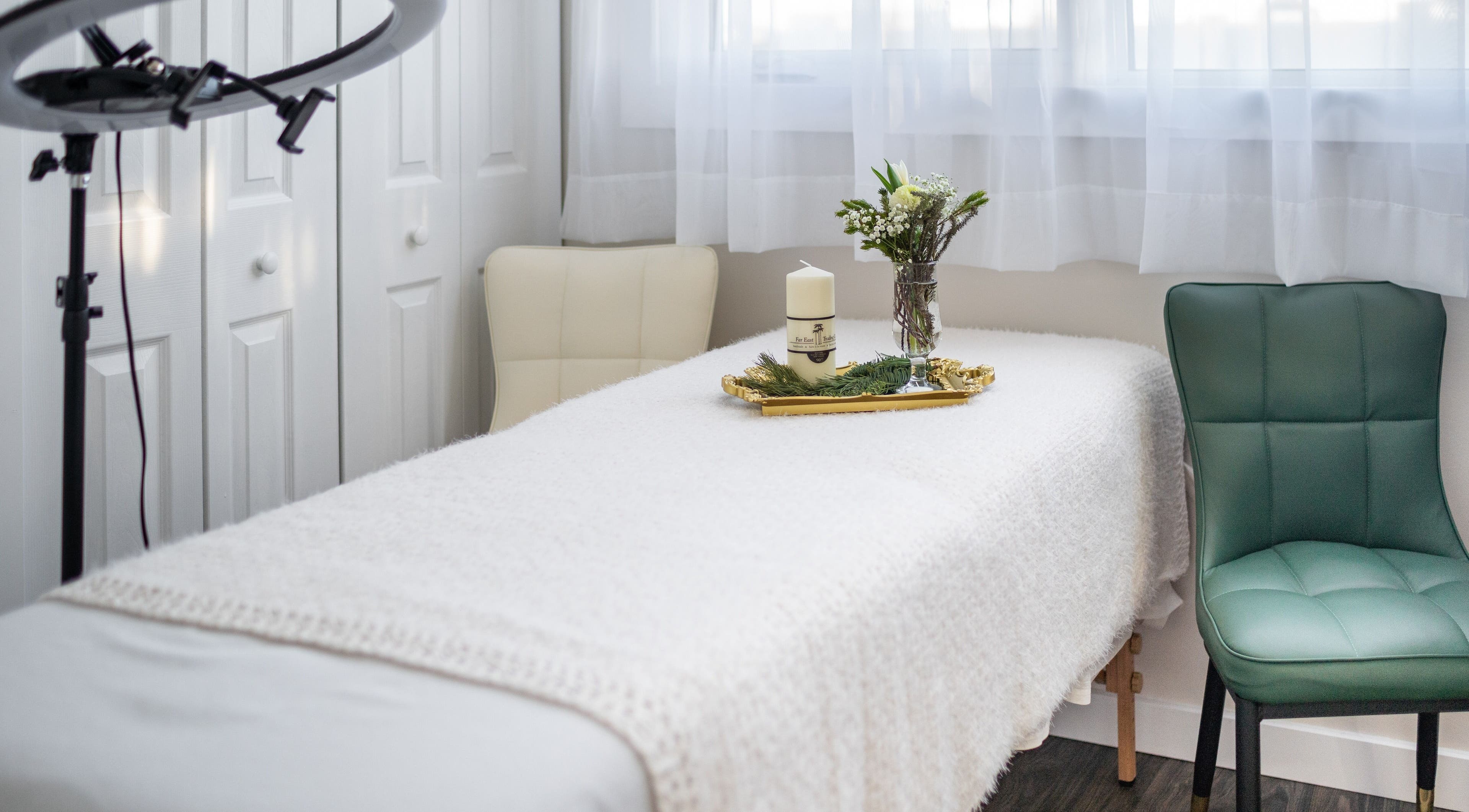 Relaxing massage room at Malva Health and Beauty Centre in Edmonton, Alberta, CA with cozy decor and soft lighting.