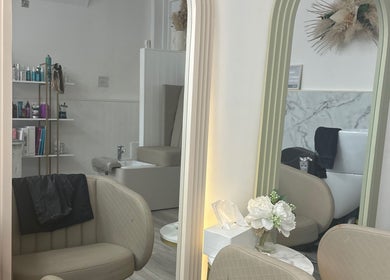 Chic interior of Braids & Fades Unisex Hair Salon in Hereford, England, GB with stylish seating and mirrors.