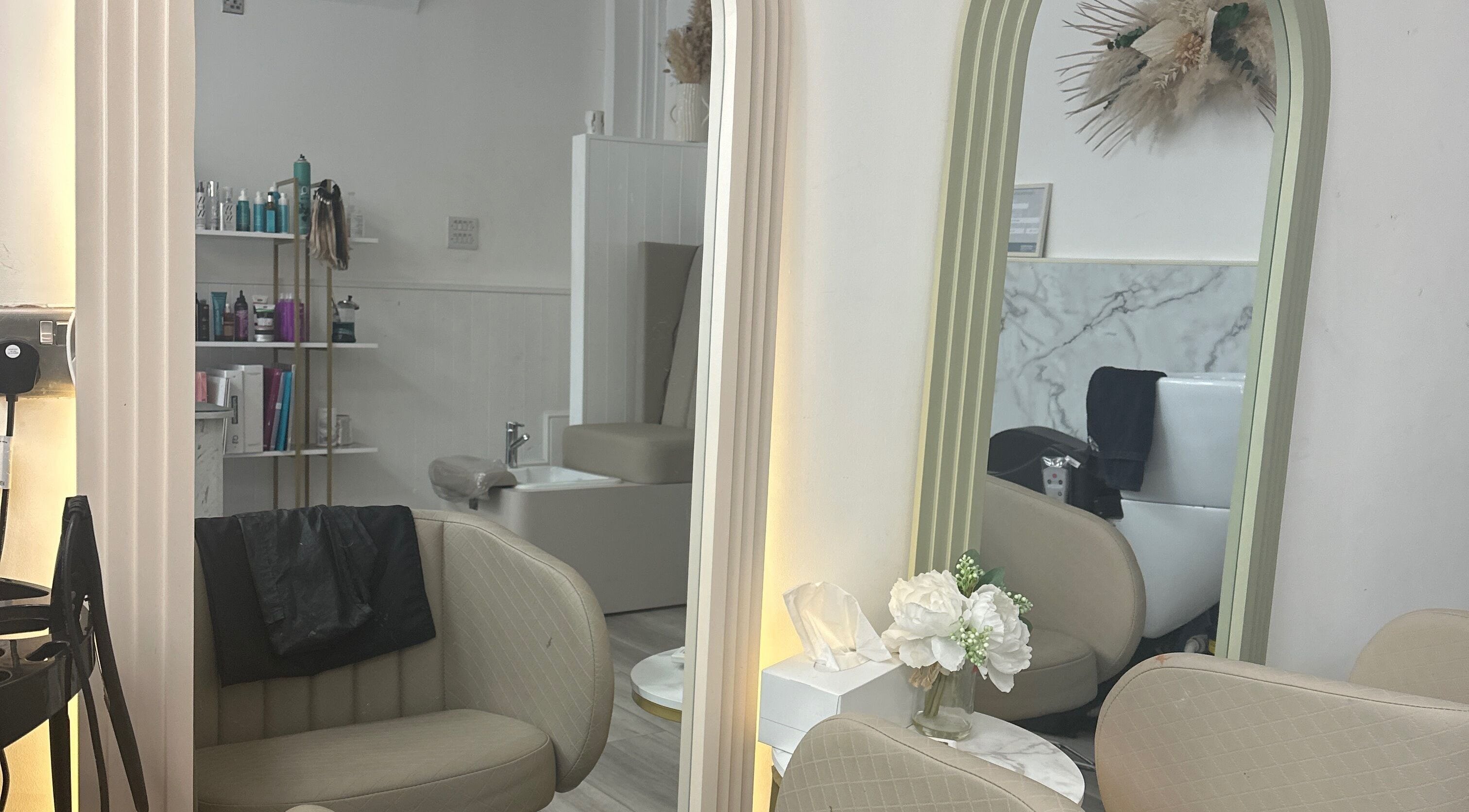 Chic interior of Braids & Fades Unisex Hair Salon in Hereford, England, GB with stylish seating and mirrors.