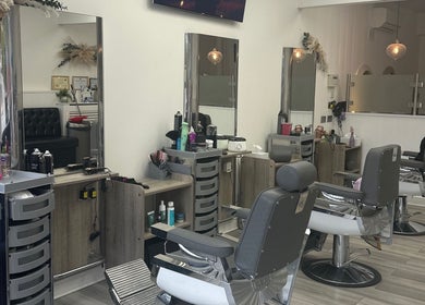 Inside Braids & Fades unisex hair salon, Hereford, England, featuring stylish chairs and sleek decor.