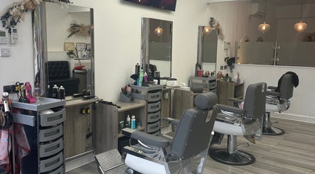Inside Braids & Fades unisex hair salon, Hereford, England, featuring stylish chairs and sleek decor.