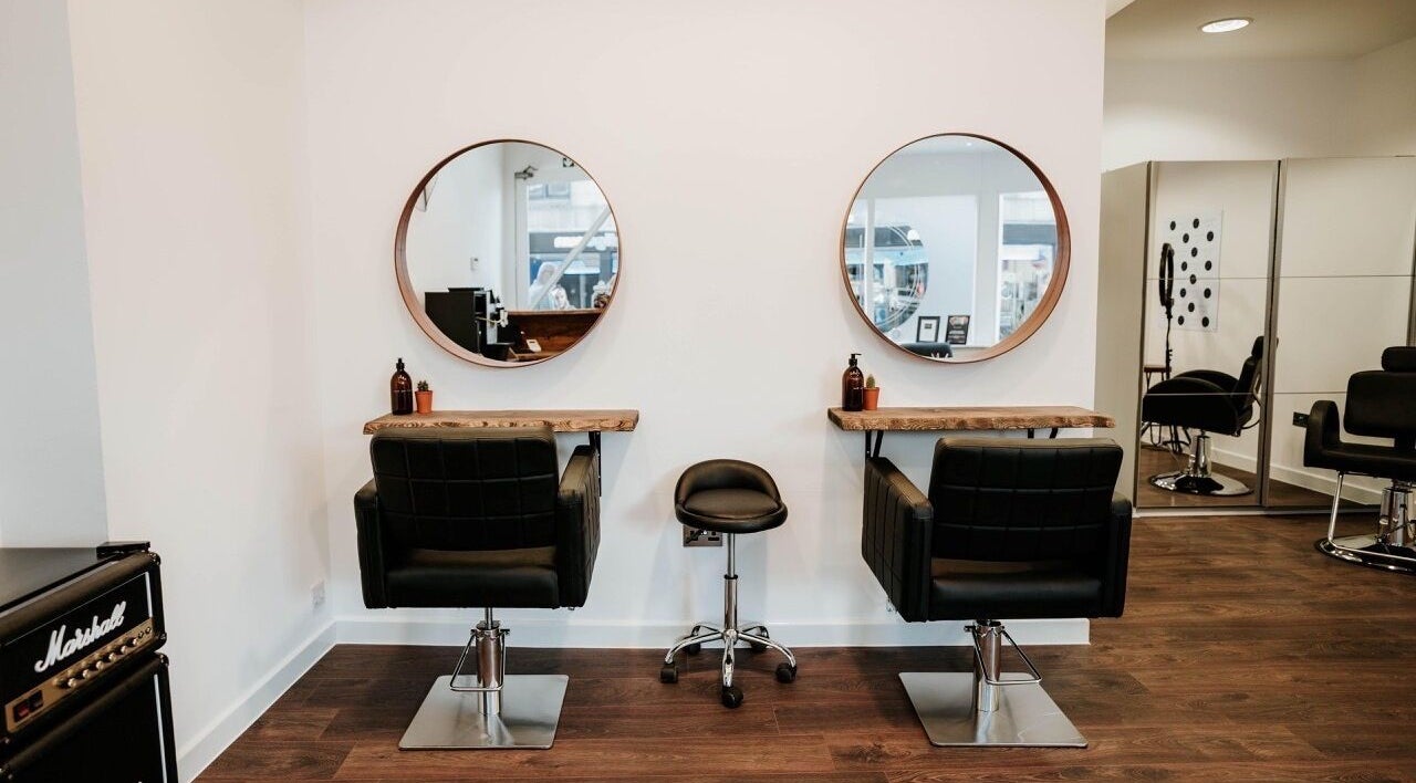 Modern salon interior at Abbie at Hendrix Hair, Aberdeen, Scotland, GB with sleek styling chairs and mirrors.