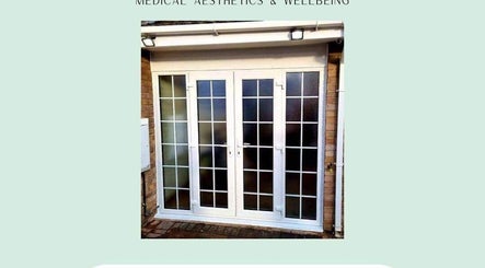 Entrance of Mes Amis Aesthetics, Abbeydale, England, featuring white double glass doors.