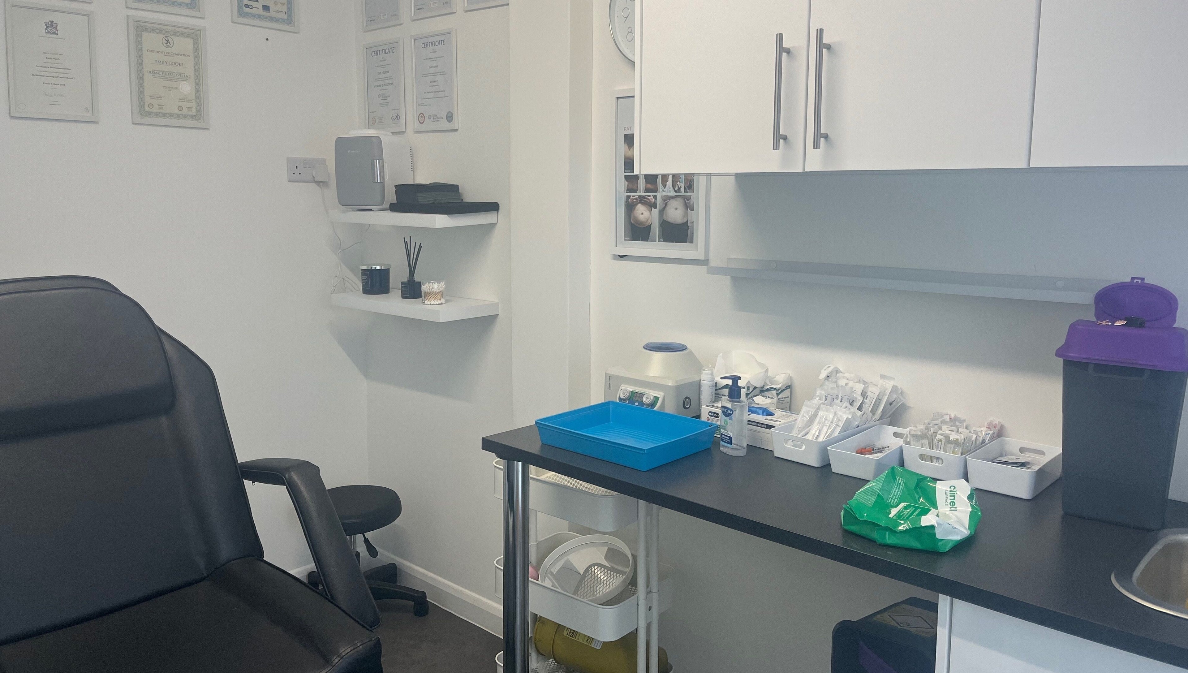 Calm treatment room at Mes Amis Aesthetics in Abbeydale, England, GB, showcasing equipment and certificates.