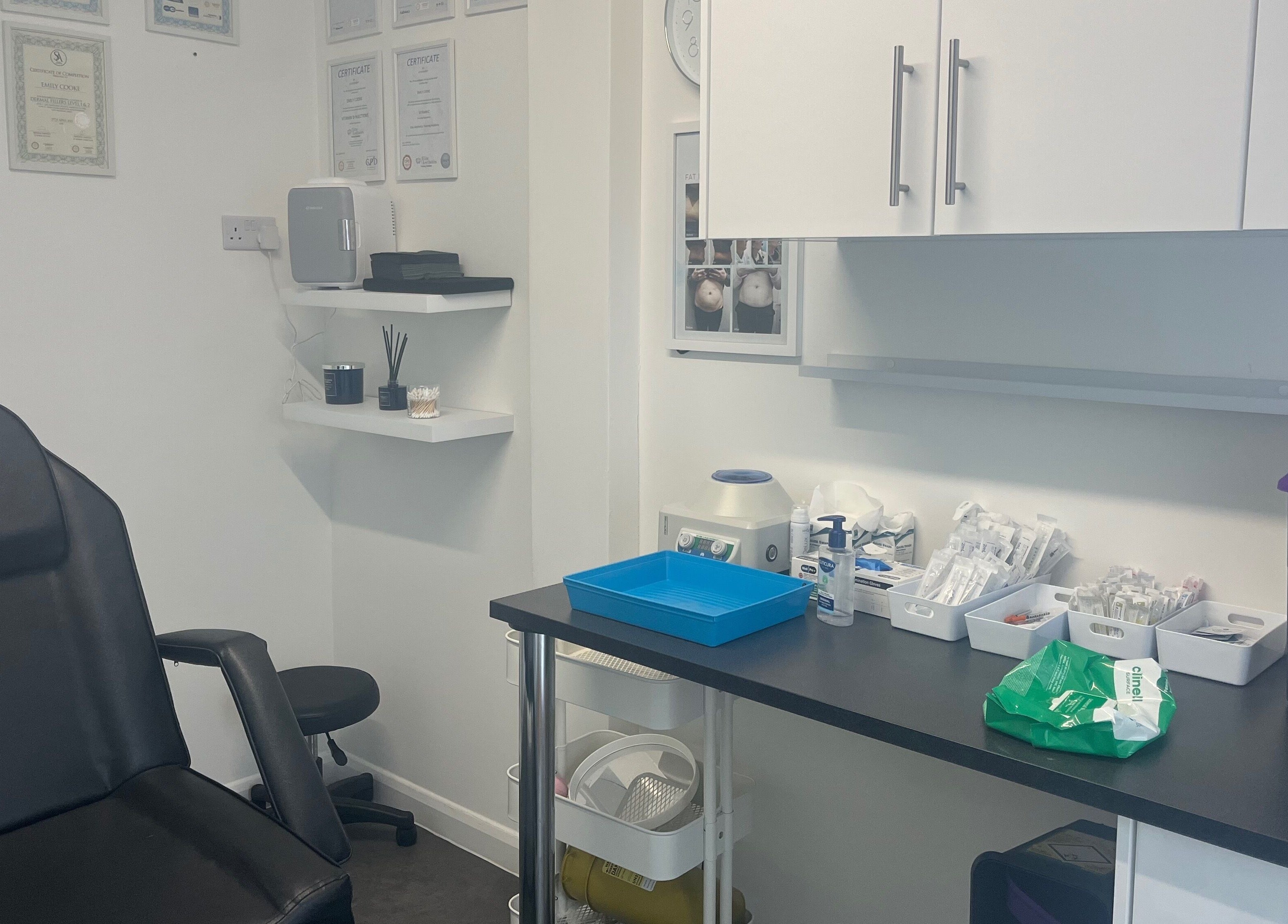 Calm treatment room at Mes Amis Aesthetics in Abbeydale, England, GB, showcasing equipment and certificates.