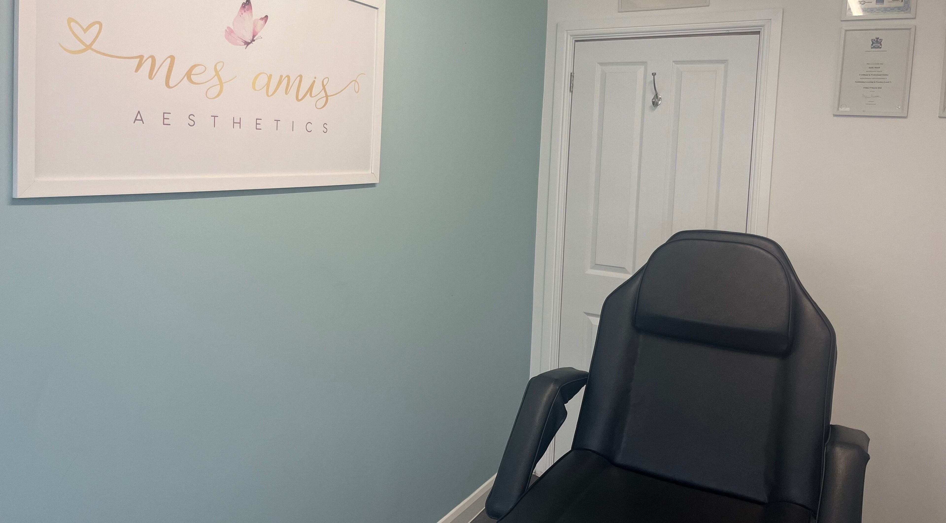 Cozy treatment room at Mes Amis Aesthetics in Abbeydale, England, featuring a comfortable chair and calming decor.