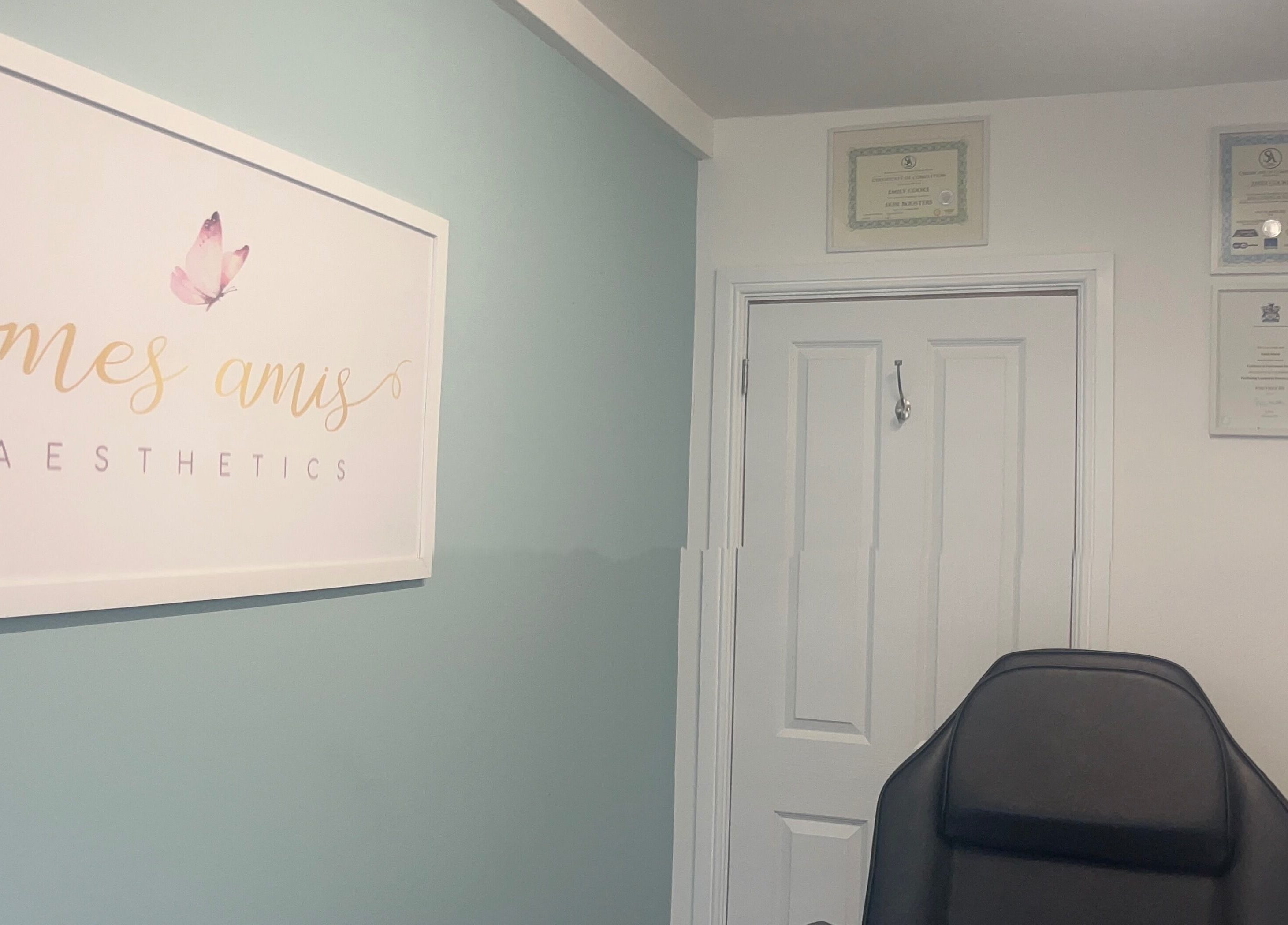 Interior of Mes Amis Aesthetics in Abbeydale, England with certificates and logo on display.
