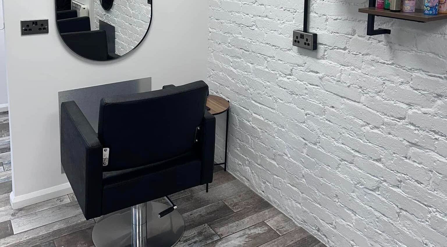 Stylish hair styling chair at No40 Hair & Beauty in Camborne, England, GB, with modern interior decor.