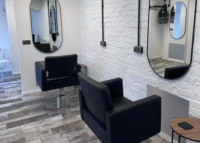 Modern salon interior with mirrors and chairs at No40 Hair & Beauty, Camborne, England, GB.